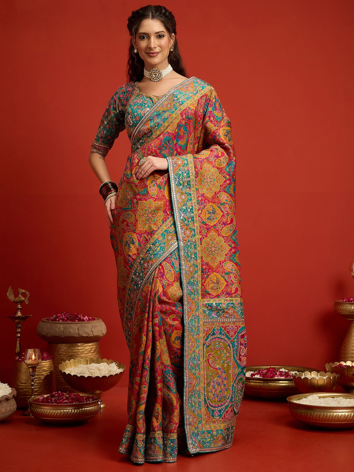 Woman wearing pink silk blend saree with traditional indian motif work and aqua blue blouse