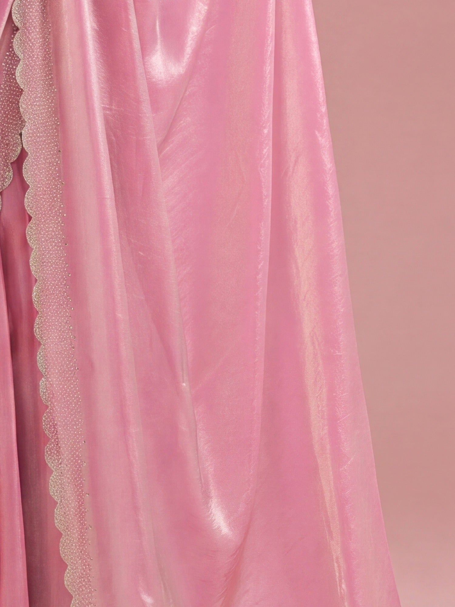 Pallu detail of pink silk saree showing ornamented surface design and embellished border