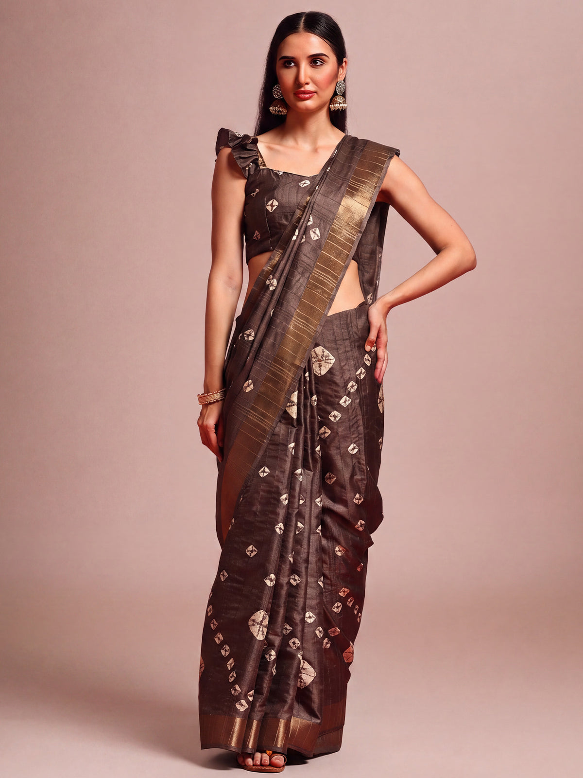 Woman wearing coffee brown silk blend saree with traditional indian motif work and coffee brown blouse