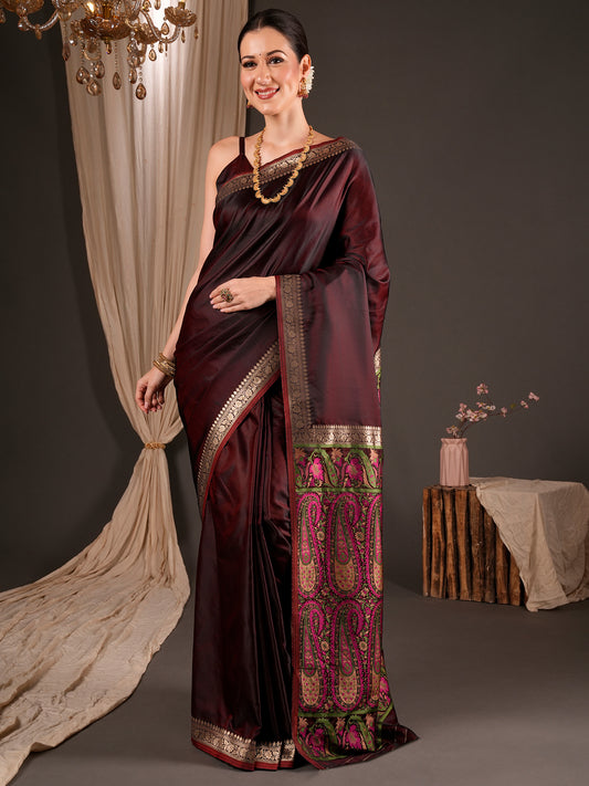 Woman wearing burgundy satin silk saree with woven motif design and burgundy blouse