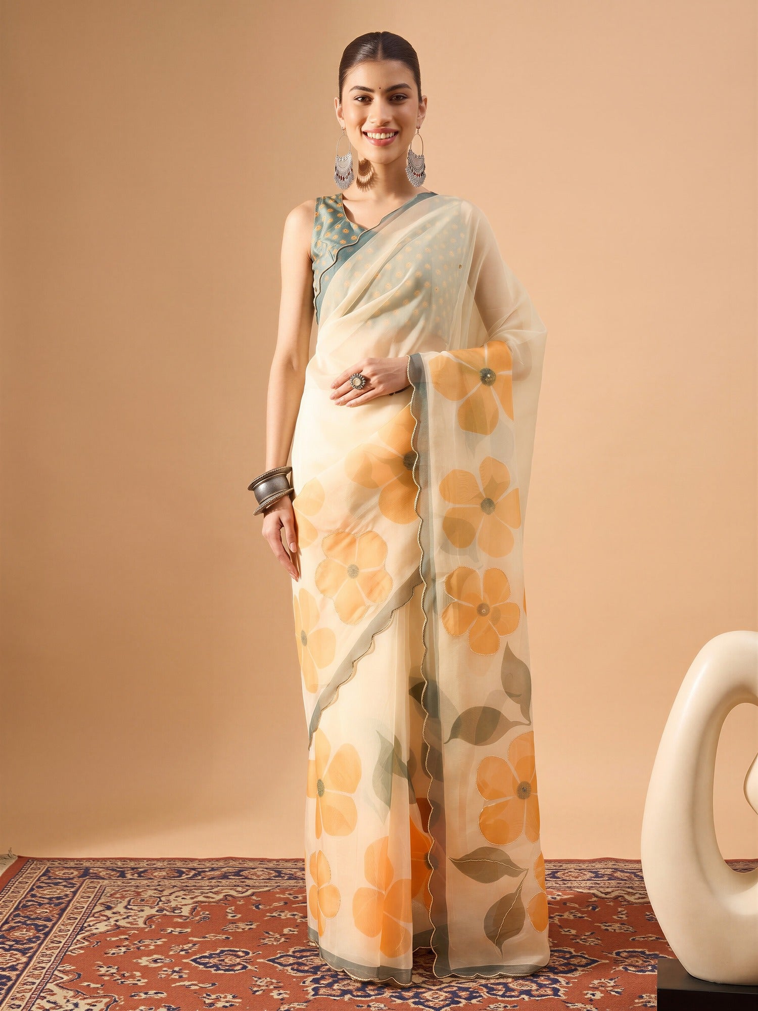 Woman wearing cream organza saree with all-over floral design and sea green blouse