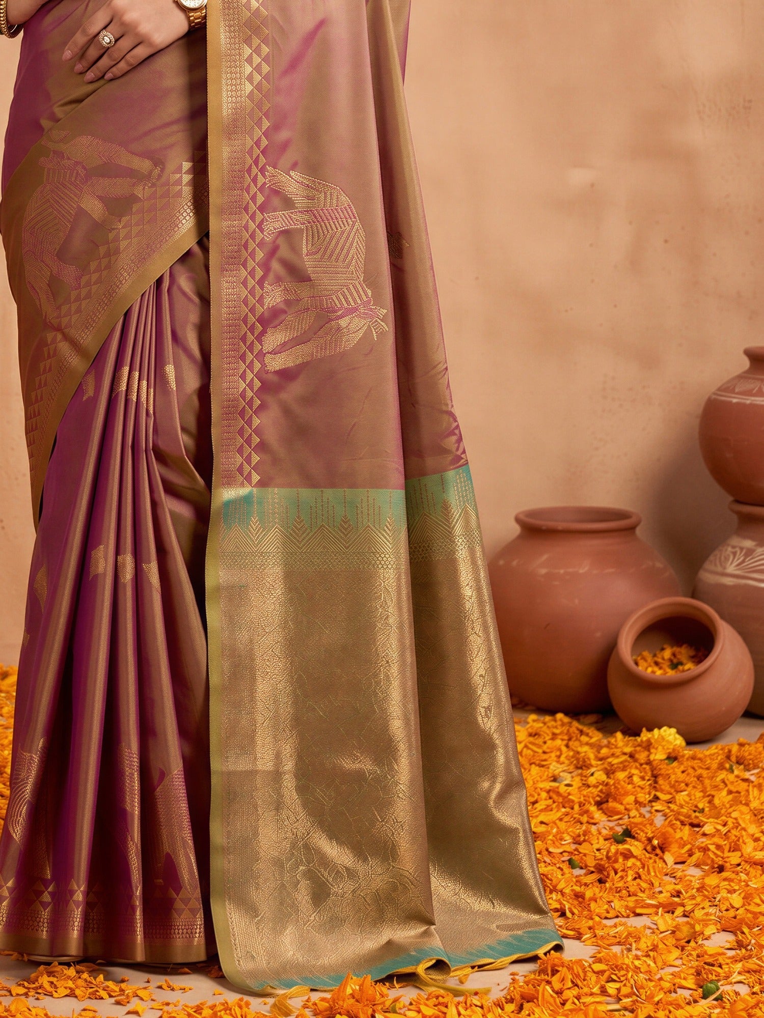 Pallu detail of brown silk saree showing animal-print design and zari border