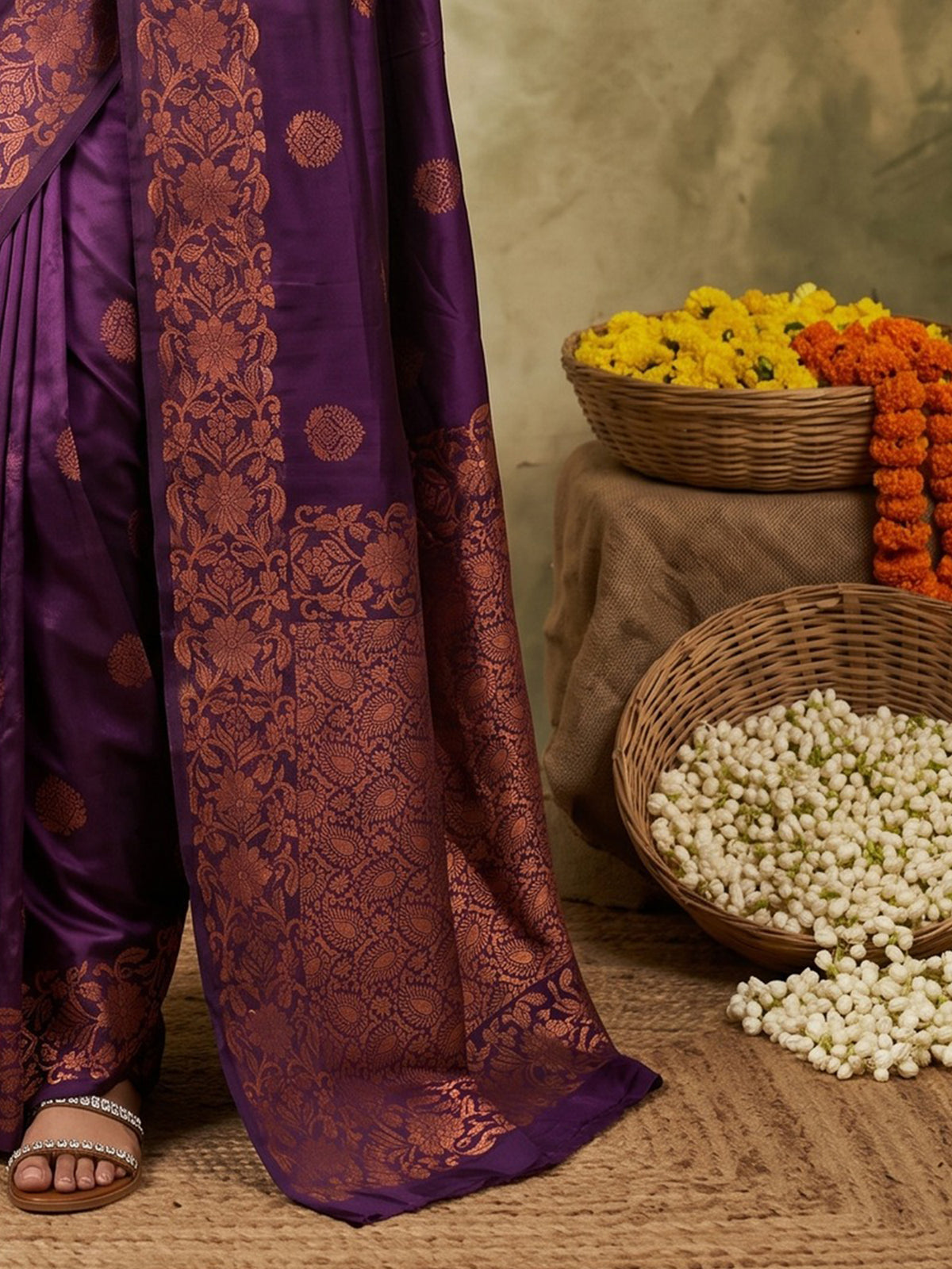 Pallu detail of purple silk blend saree showing zari butta (metallic motif) work and zari border