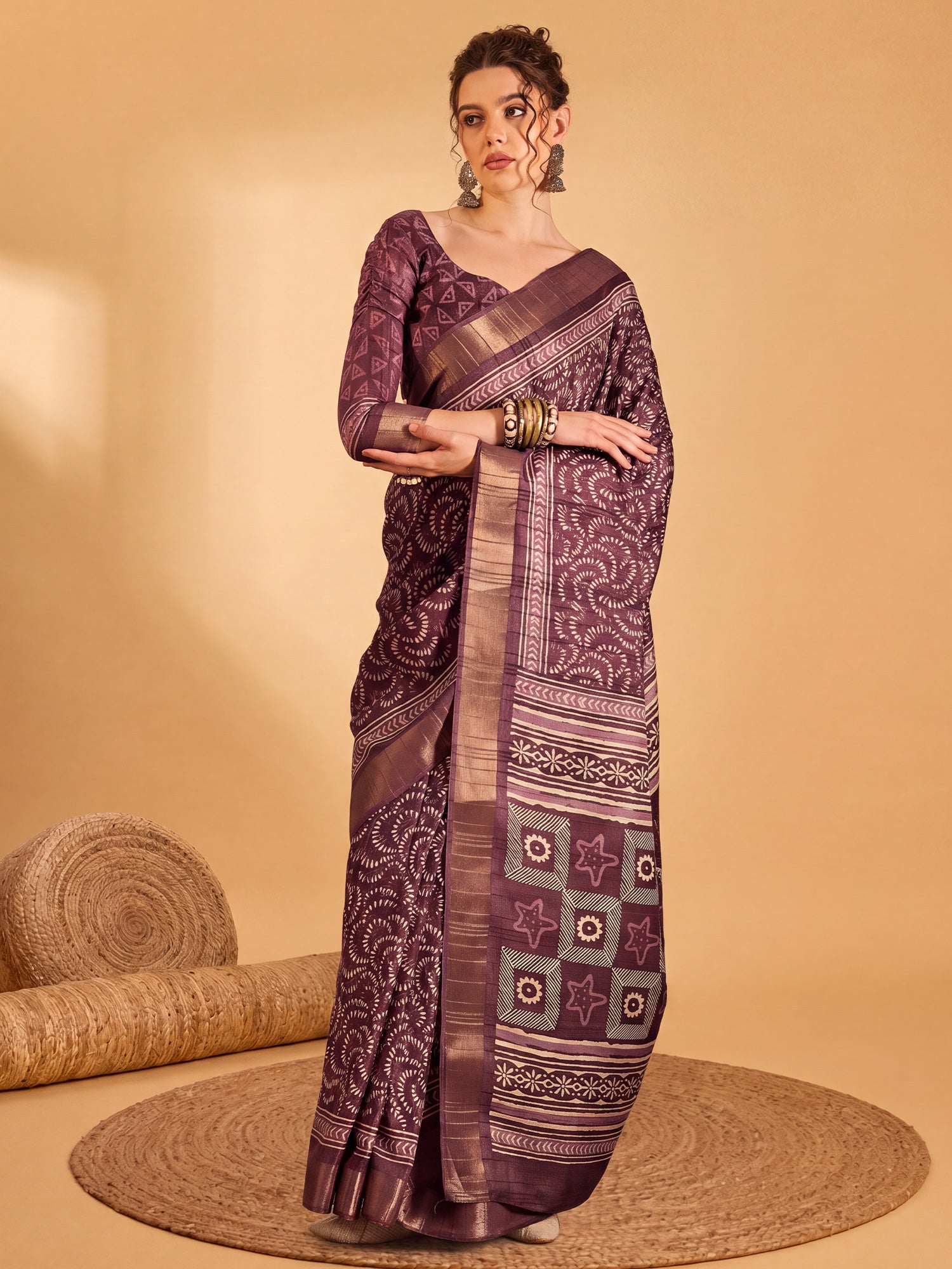 Woman wearing wine silk blend saree with traditional indian motif work and wine blouse