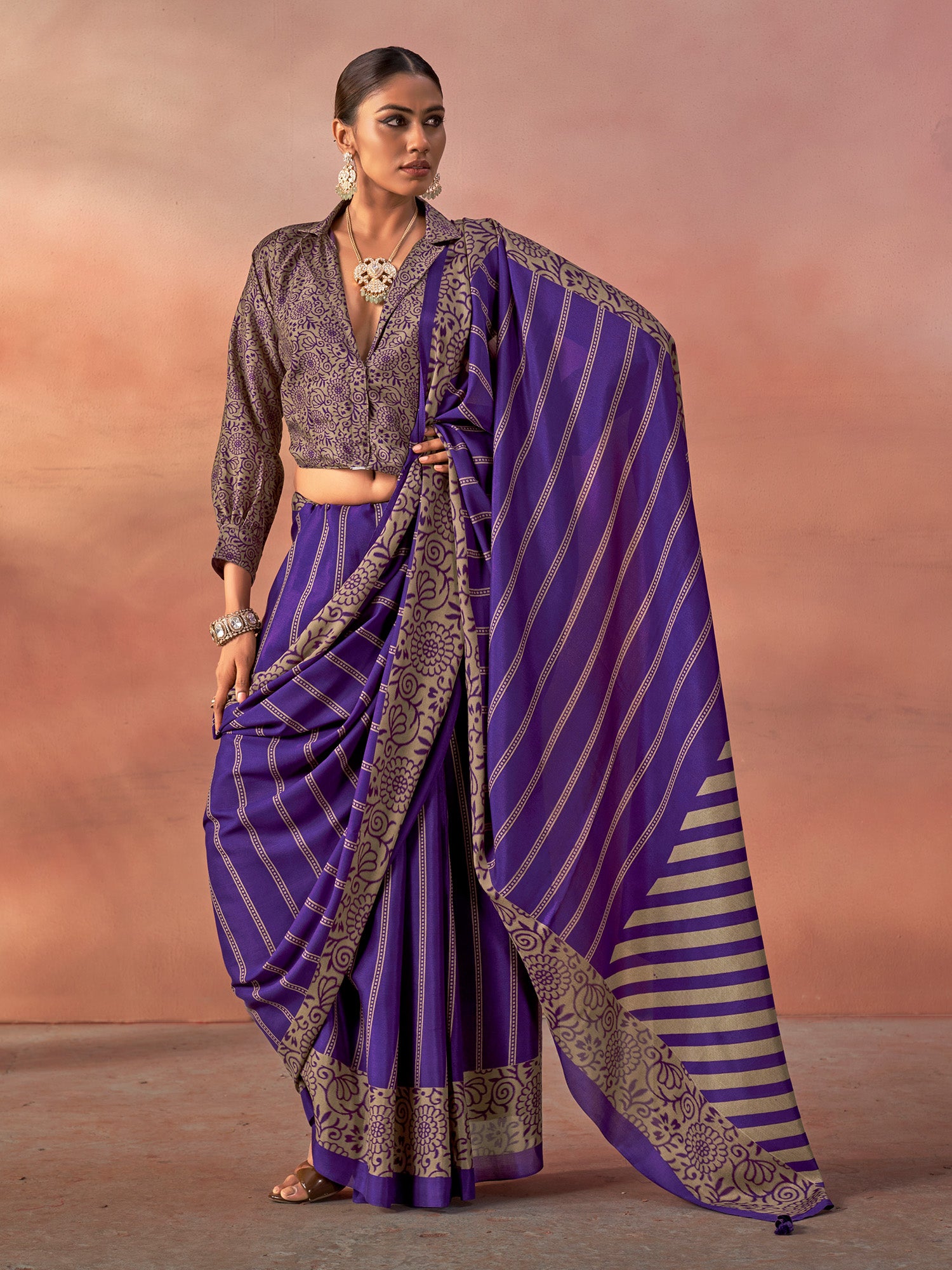 Woman wearing purple silk blend saree with traditional indian motif work and purple blouse