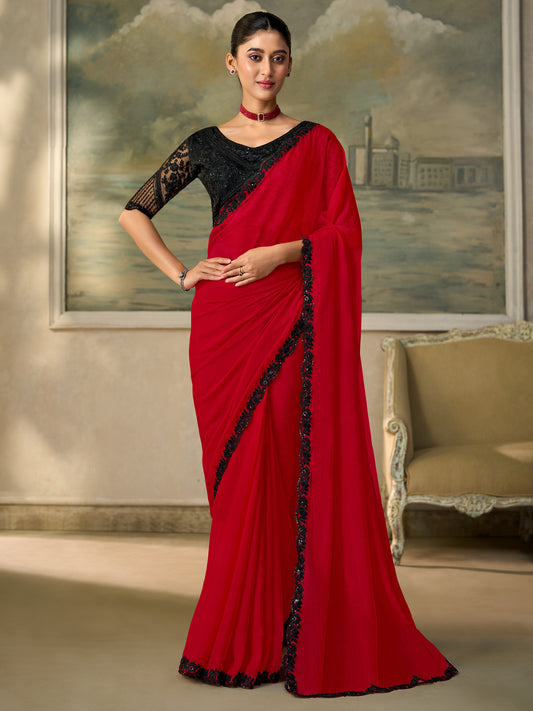 Woman wearing red chiffon saree with embroidered motif work and black blouse