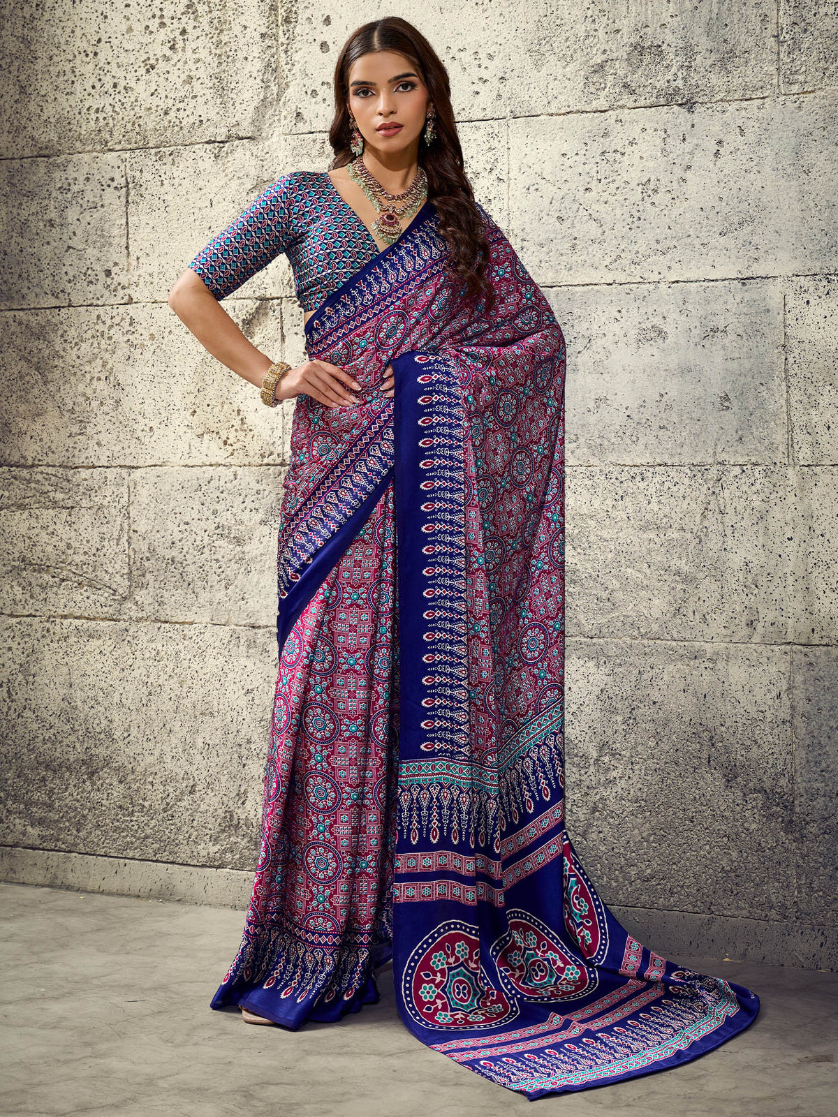 Woman wearing blue satin saree with ajrak block-print motif work and blue blouse