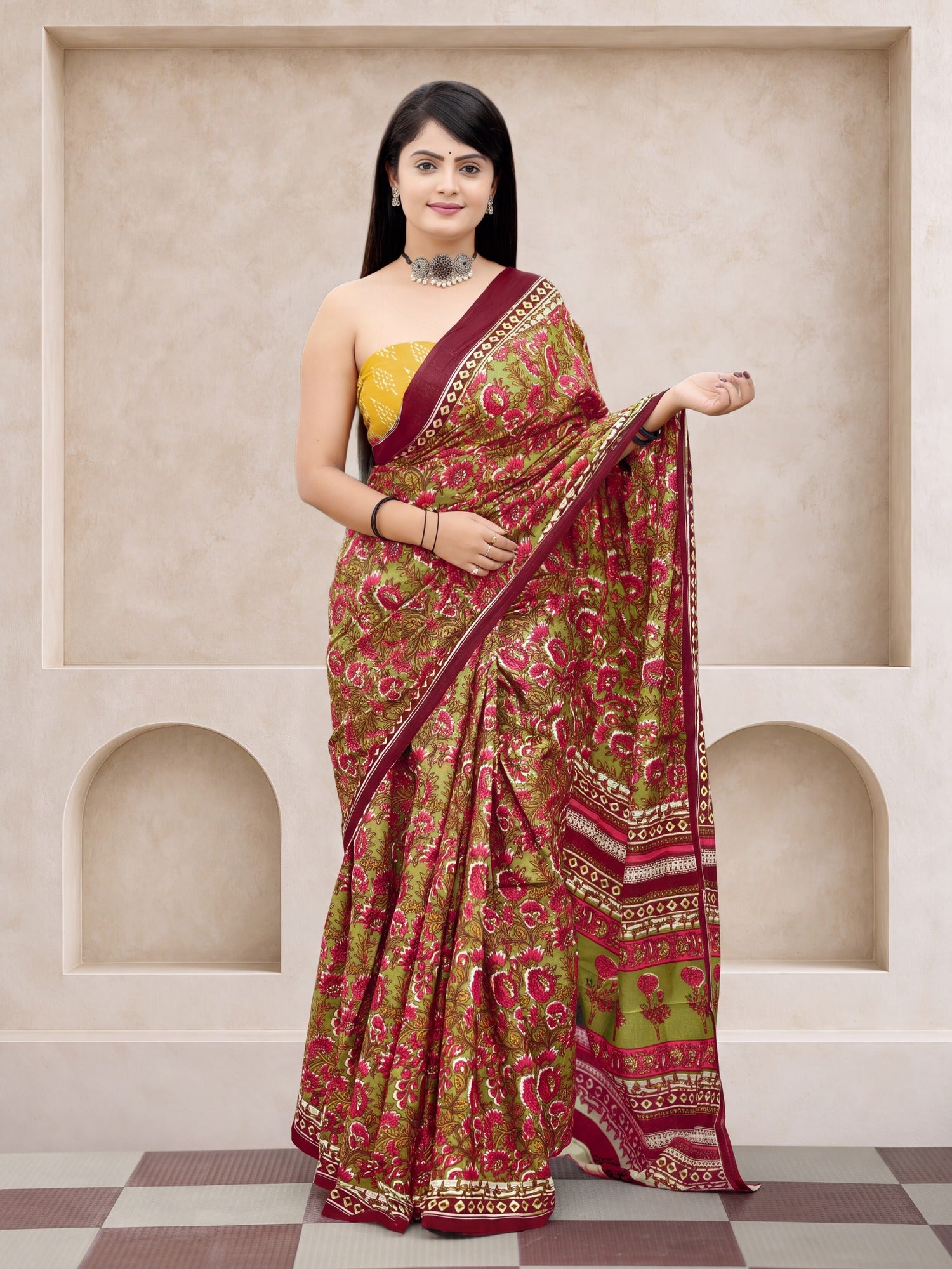 Woman wearing olive cotton saree with botanical floral and leaf design and mustard blouse