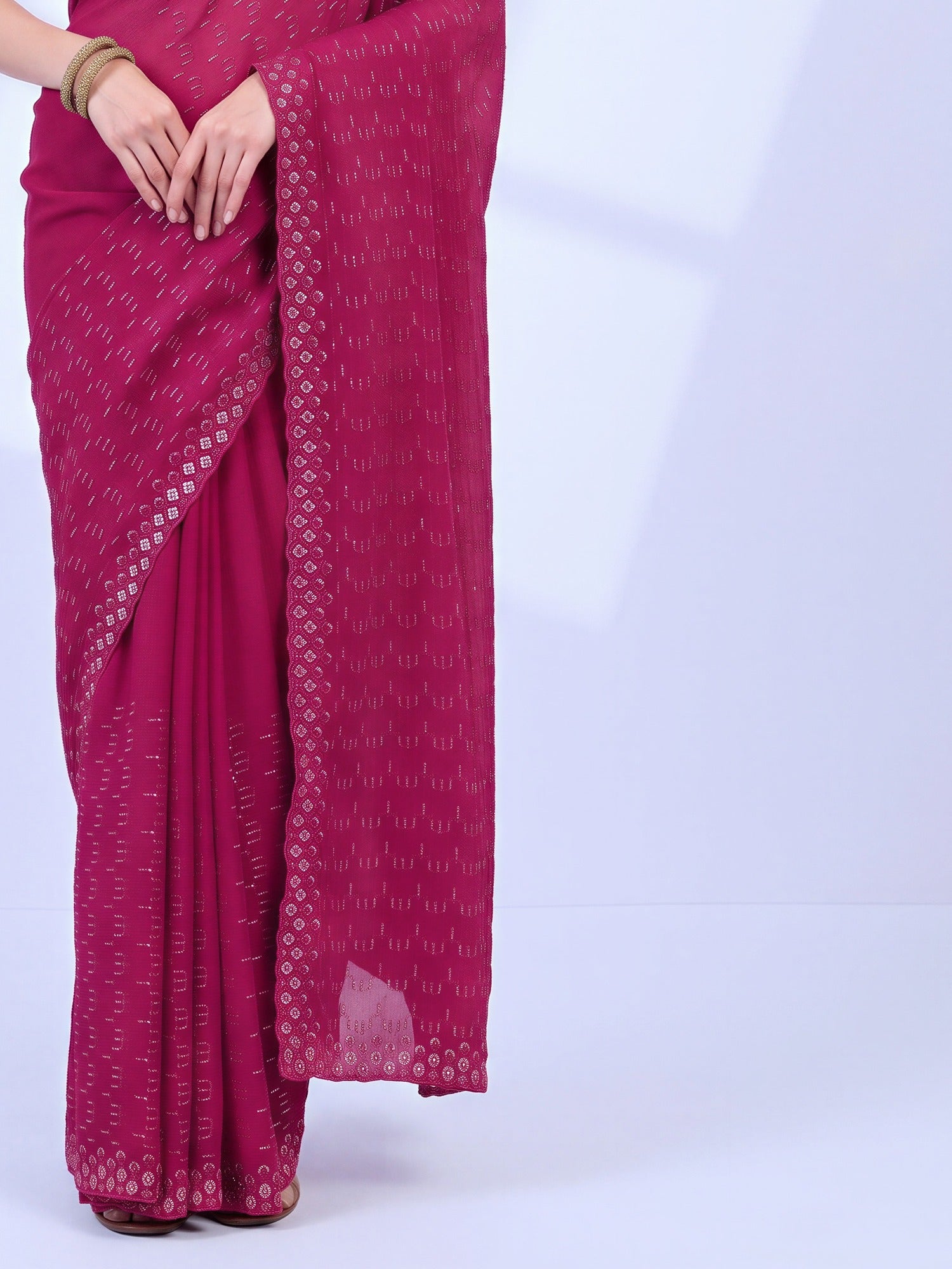 Pallu detail of teal blue tissue saree showing ornamented surface design and embellished border
