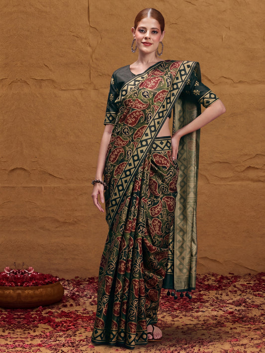 Woman wearing dark green silk blend saree with traditional indian motif work and dark green blouse