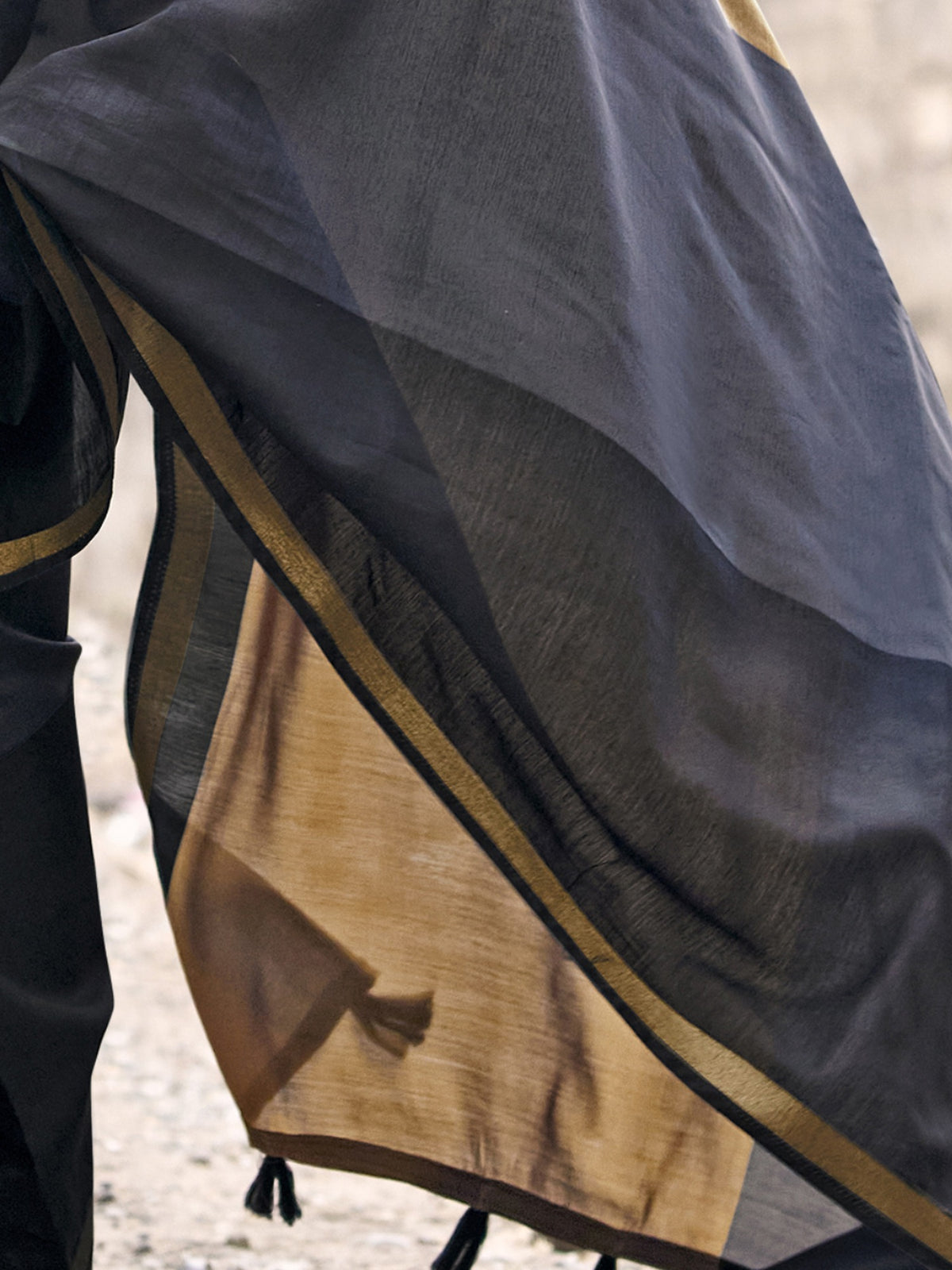 Pallu detail of black cotton blend saree showing colorblocked design and zari border