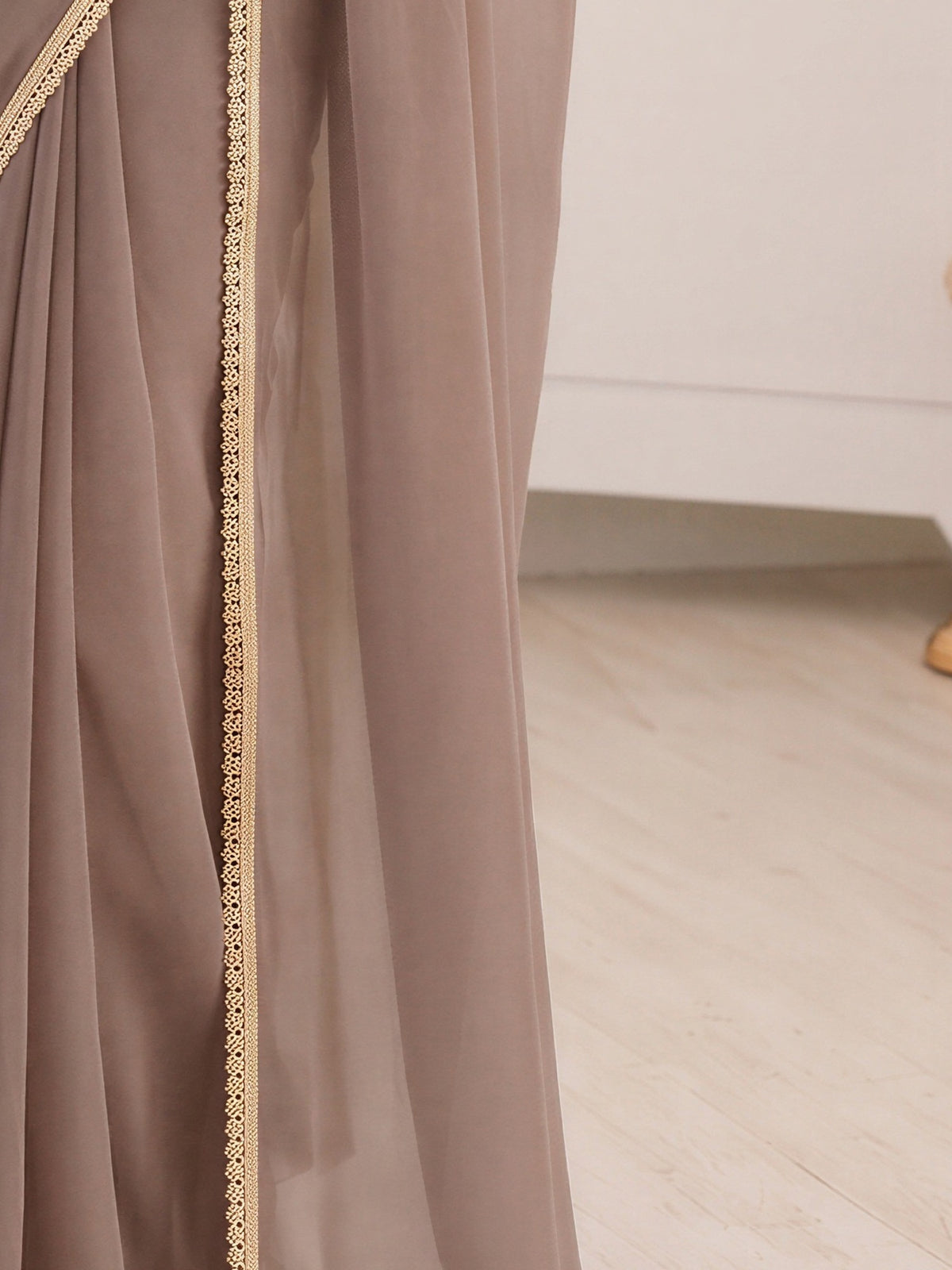 Pallu detail of grey satin silk saree showing clean solid-tone finish and embellished border