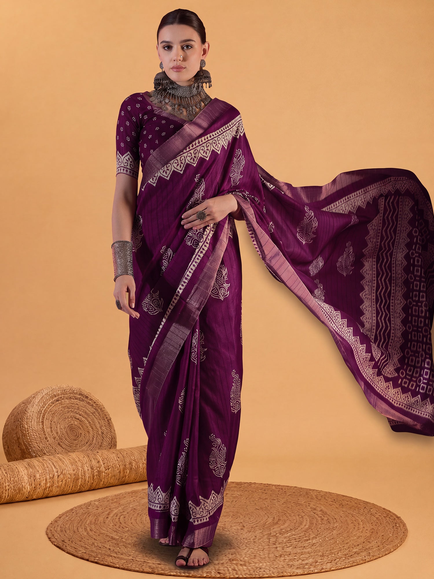 Woman wearing purple silk blend saree with dabu mud-resist print work and purple blouse