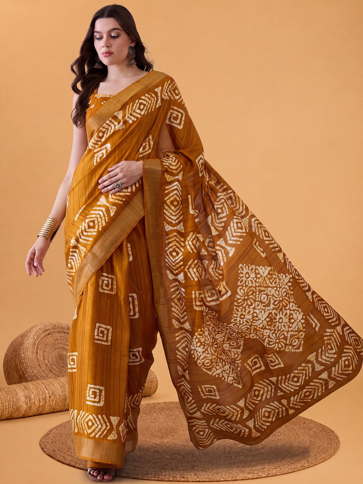 Woman wearing mustard silk blend saree with batik wax-resist design and mustard blouse