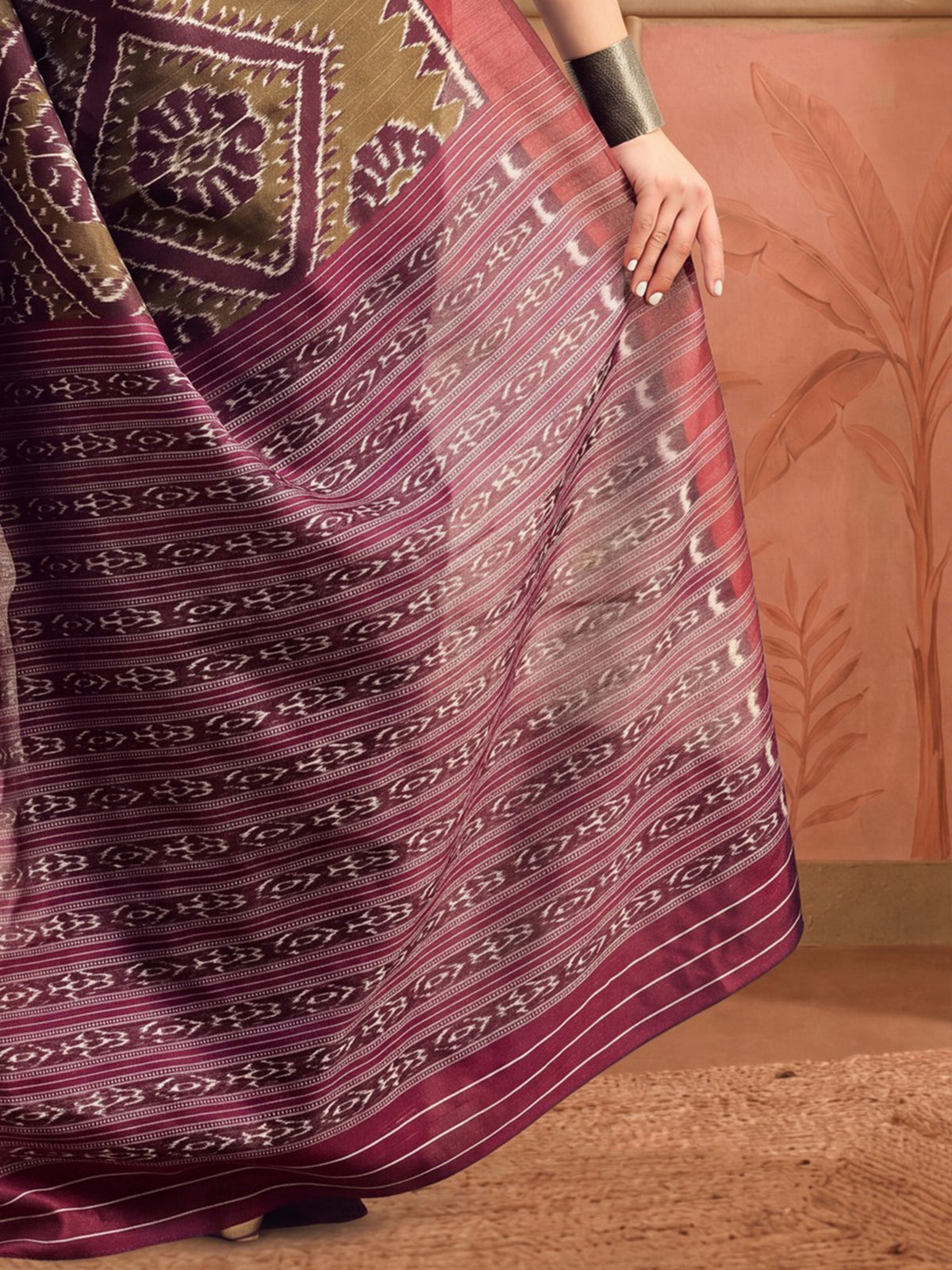 Pallu detail of olive bhagalpuri silk saree showing ikat resist-dyed pattern and printed border