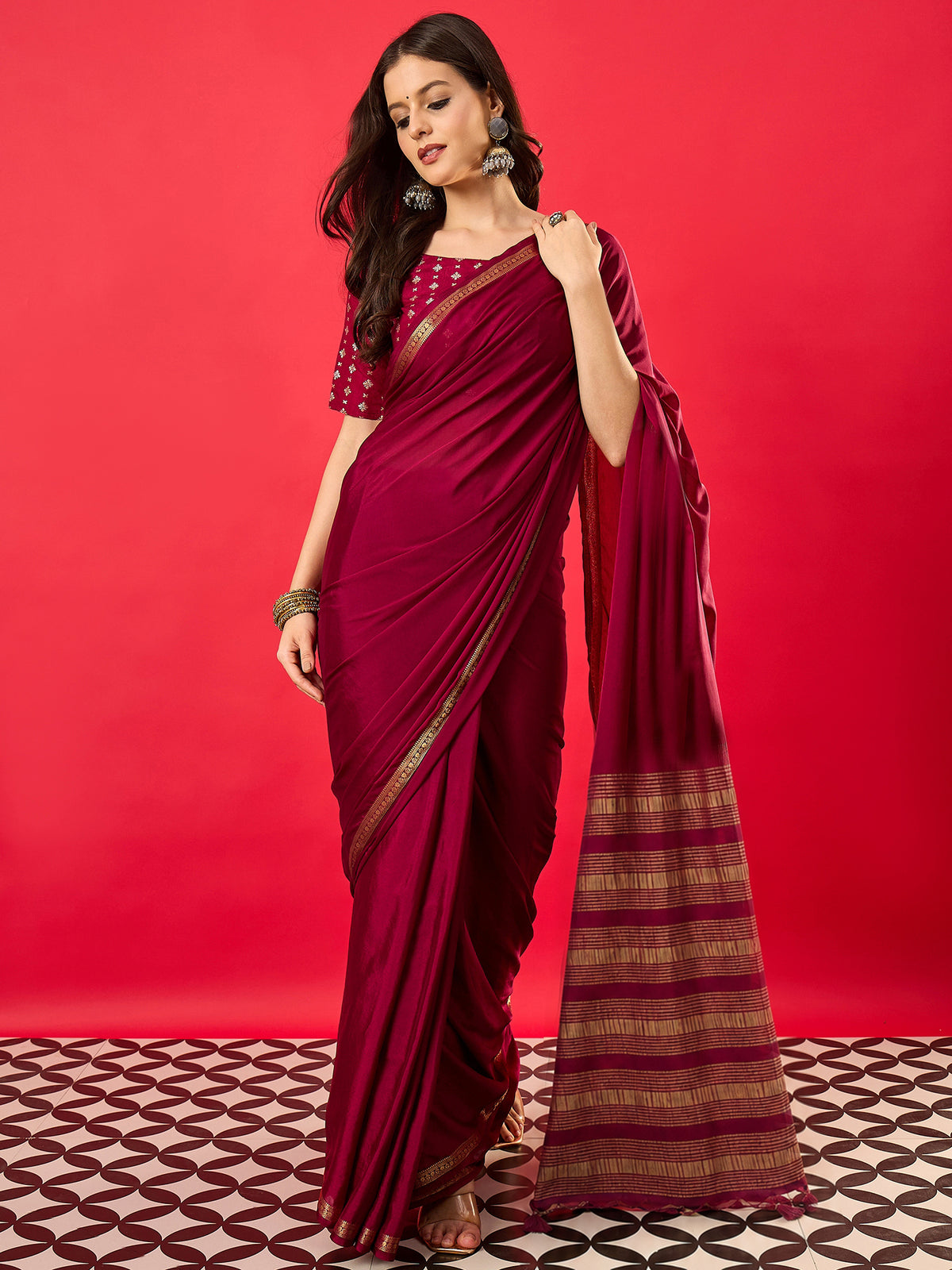 Woman wearing burgundy mysore silk saree with traditional indian motif work and burgundy blouse