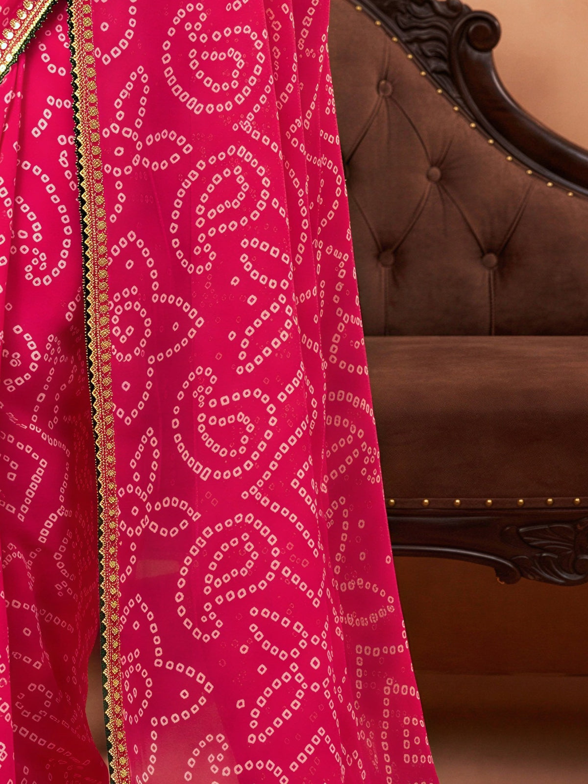 Pallu detail of pink georgette saree showing bandhani tie-dye dot work and embellished border