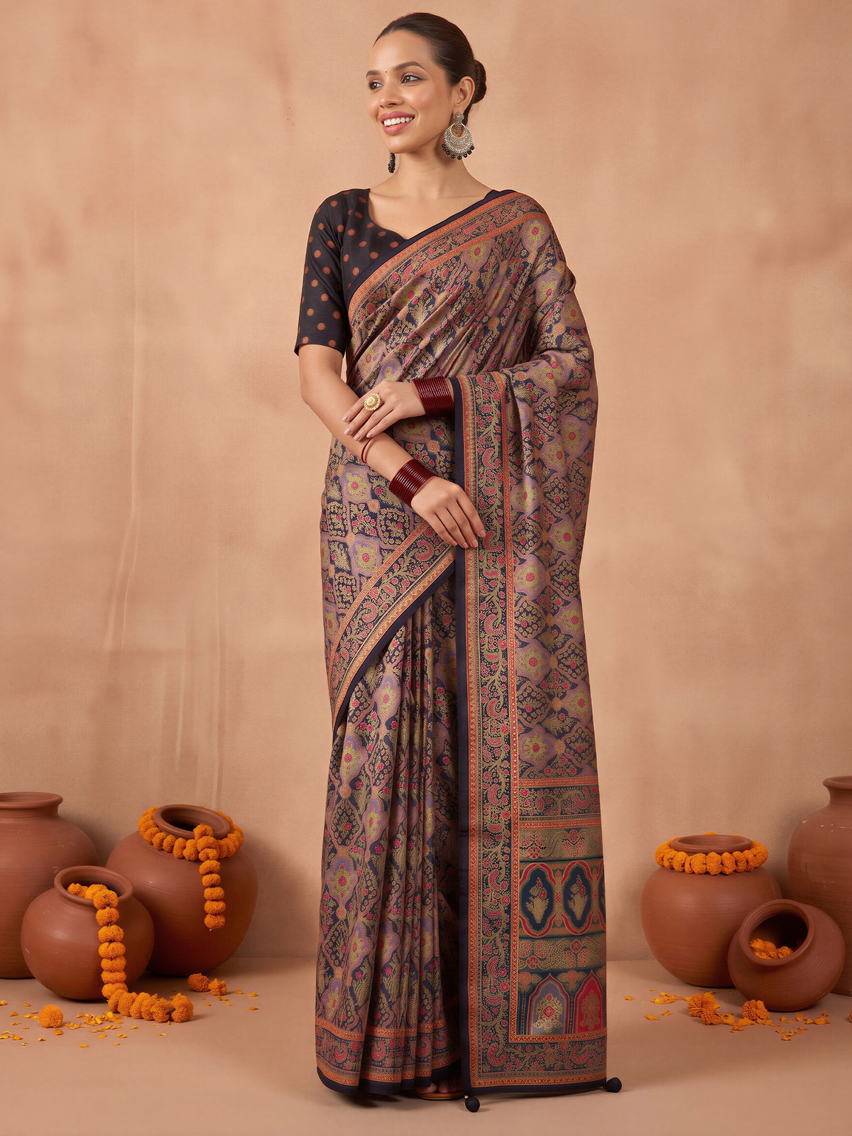 Woman wearing black silk blend saree with metallic foil print work and black blouse
