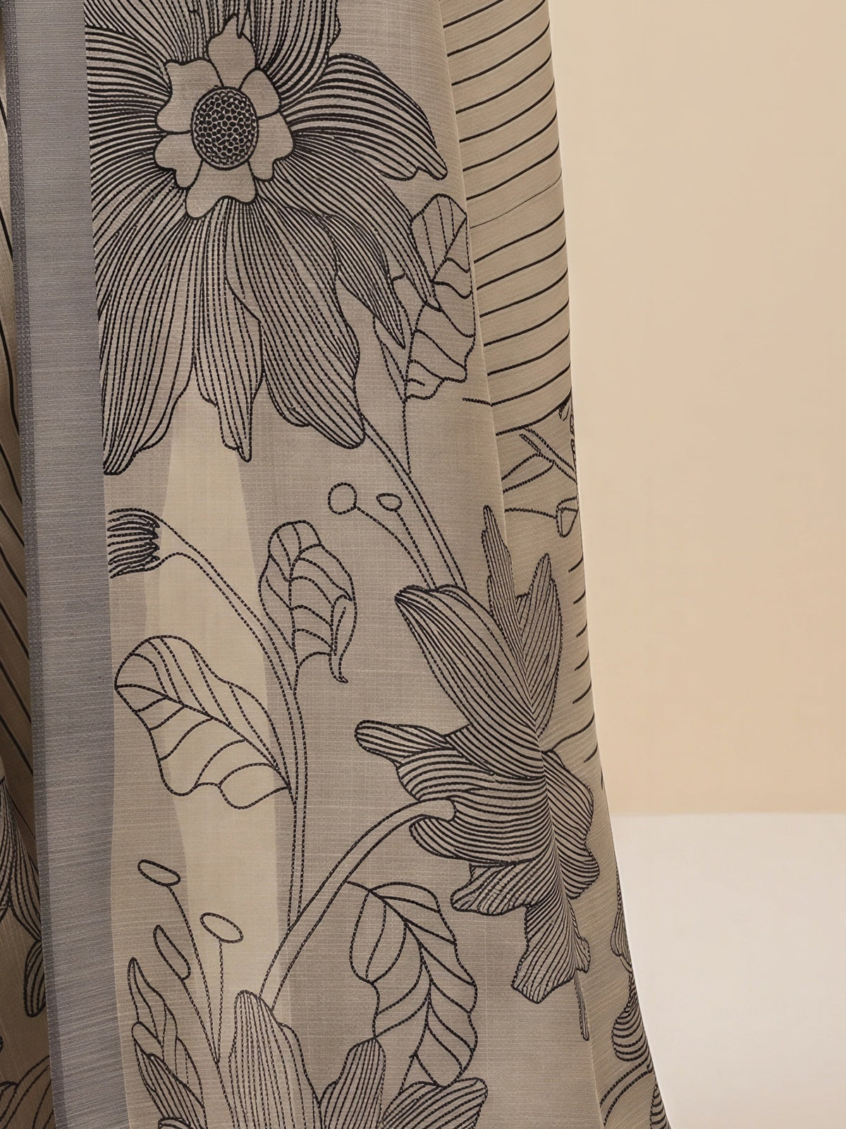 Pallu detail of beige silk blend saree showing traditional indian motif work and woven design border