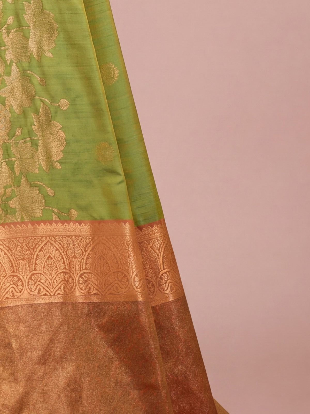 Pallu detail of green tussar silk saree showing traditional indian motif work and zari border