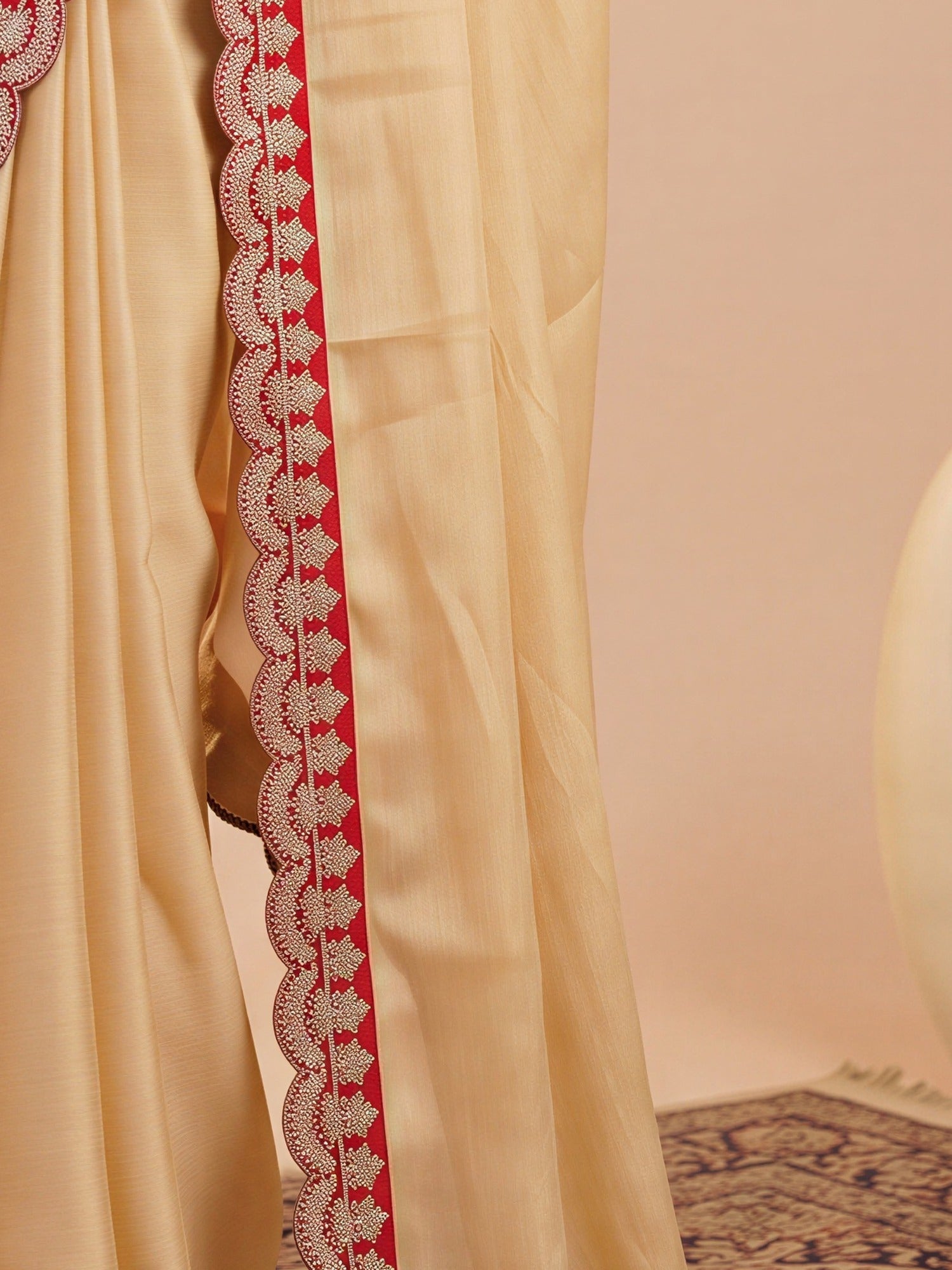 Pallu detail of cream satin saree showing clean solid-tone finish and solid border