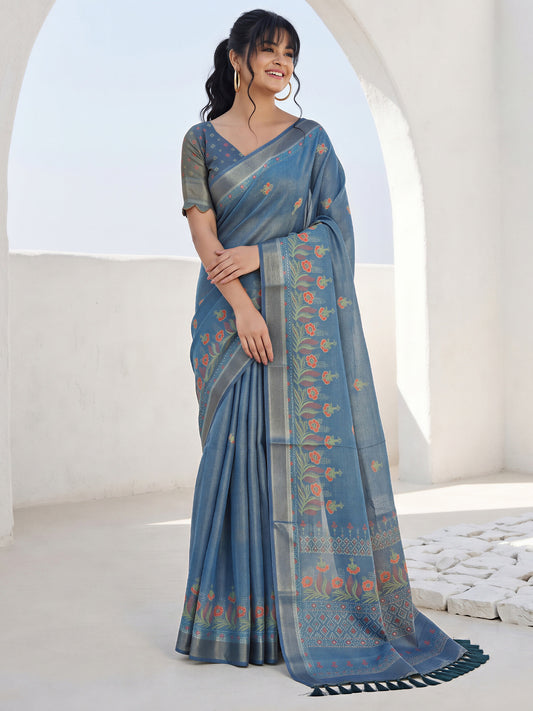 Woman wearing teal blue cotton silk saree with traditional indian motif work and teal blue blouse