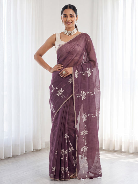 Woman wearing wine cotton linen saree with all-over floral design and white blouse