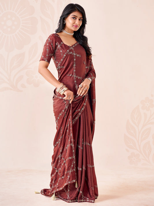 Woman wearing coffee brown chiffon saree with ornamented surface design and coffee brown blouse