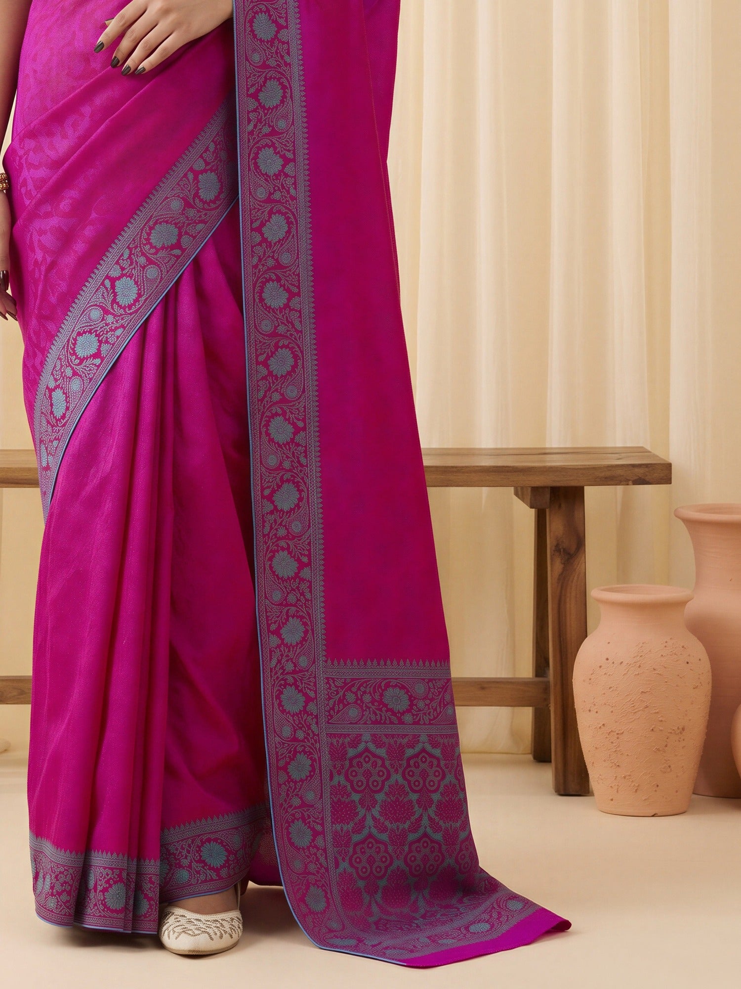 Pallu detail of magenta silk blend saree showing traditional indian motif work and woven design border