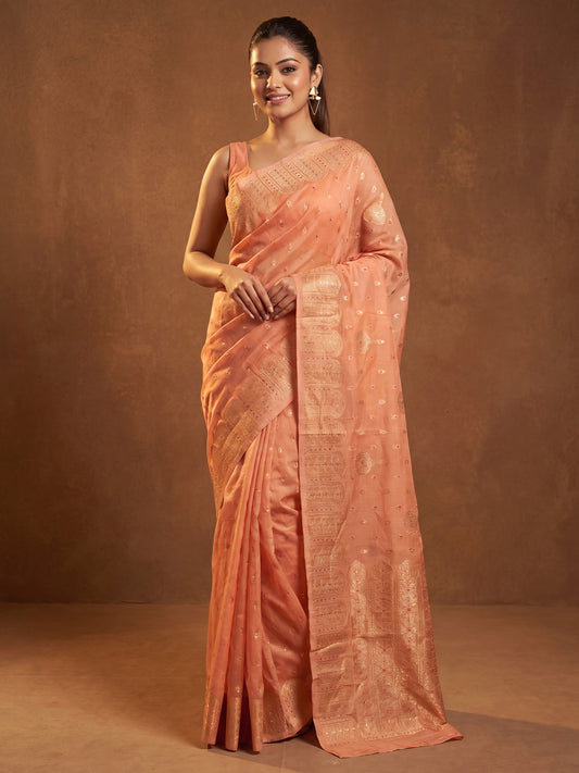 Woman wearing orange silk blend saree with zari butta (metallic motif) work and orange blouse