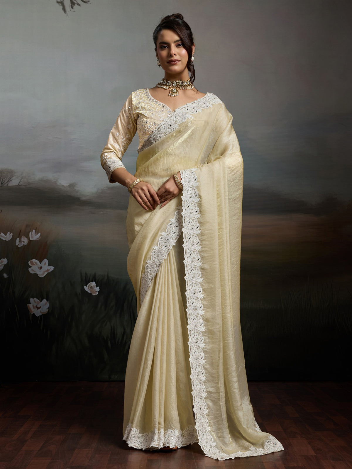 Woman wearing off white satin silk saree with clean solid-tone finish and off white blouse