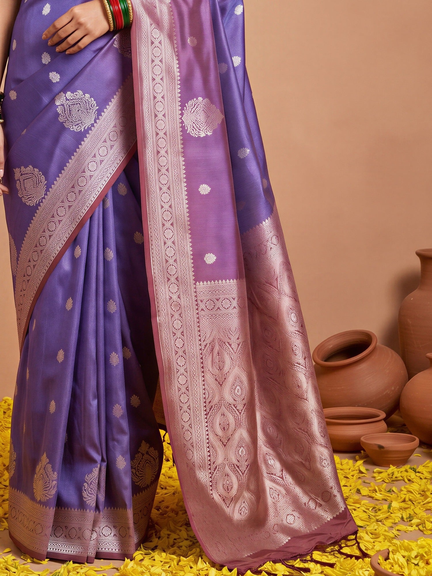 Pallu detail of purple cotton blend saree showing ornamented surface design and solid border