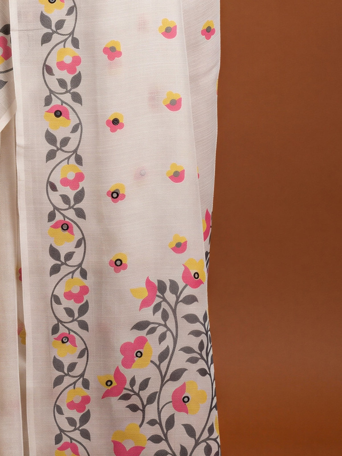 Pallu detail of off white linen blend saree showing all-over floral design and printed border