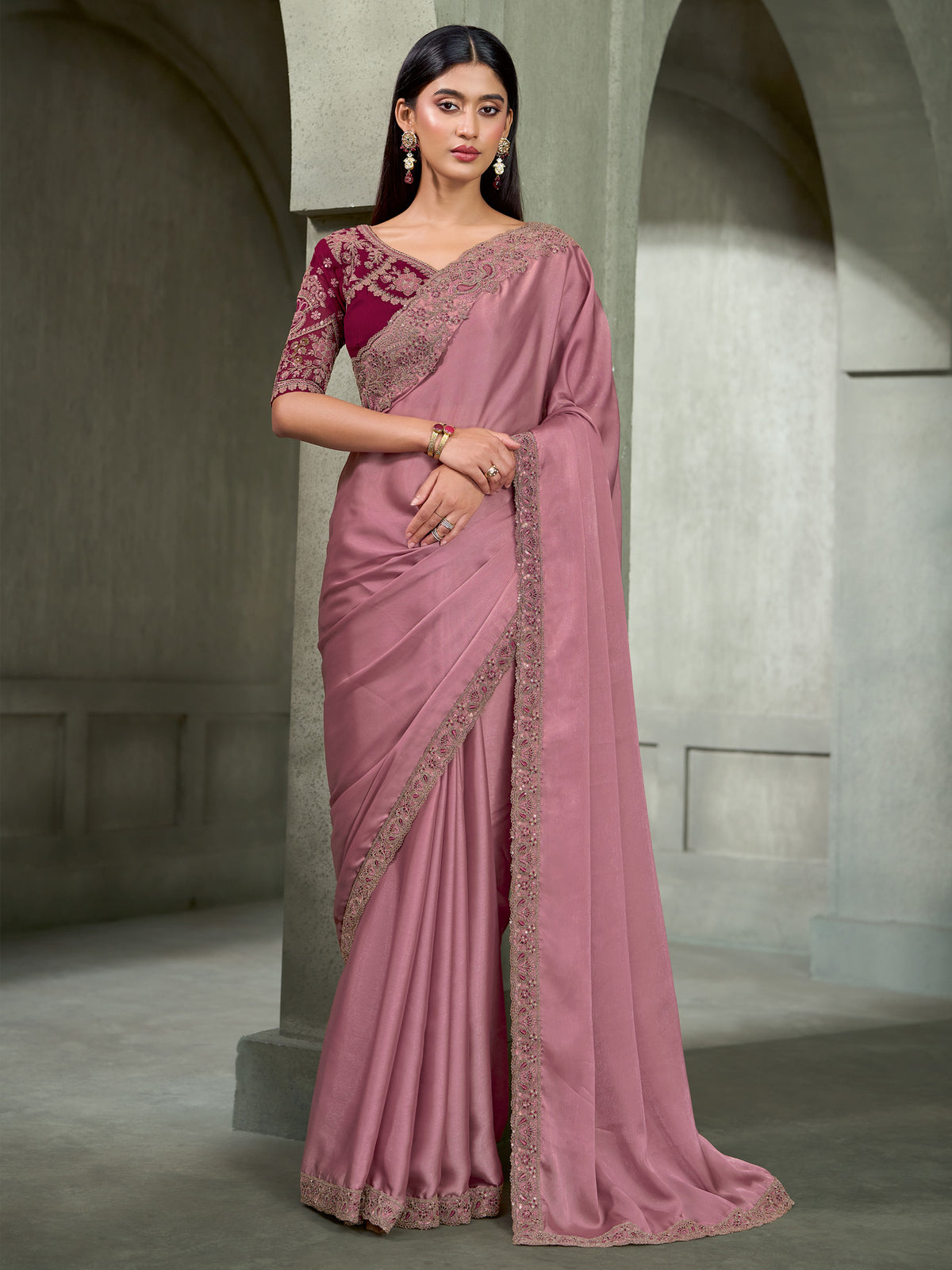 Woman wearing mauve georgette saree with embroidered motif work and magenta blouse