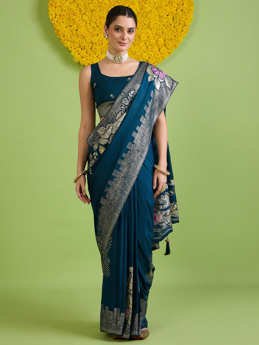 Woman wearing teal blue silk blend saree with all-over floral design and teal blue blouse