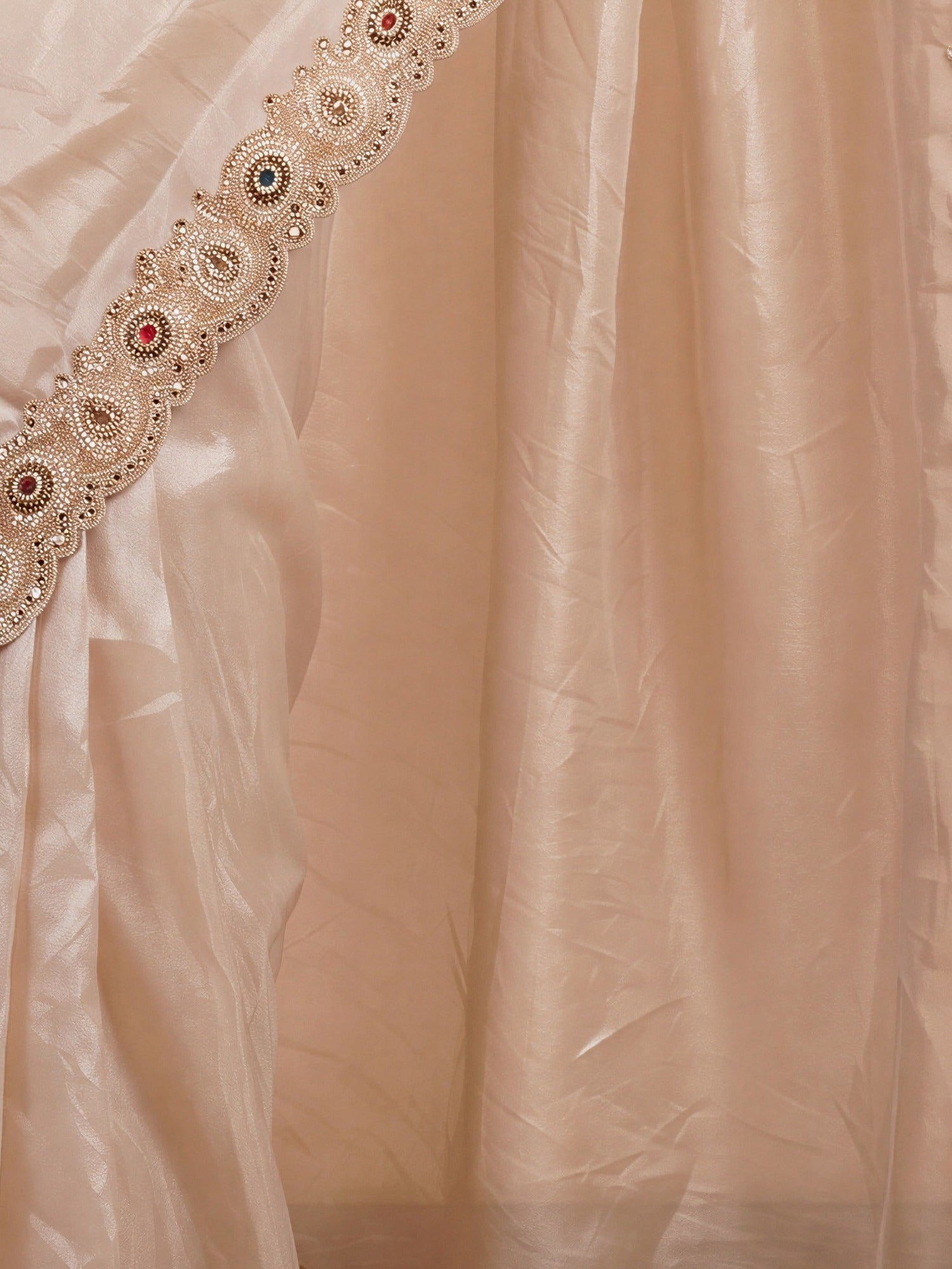 Pallu detail of off white satin saree showing ornamented surface design and embellished border