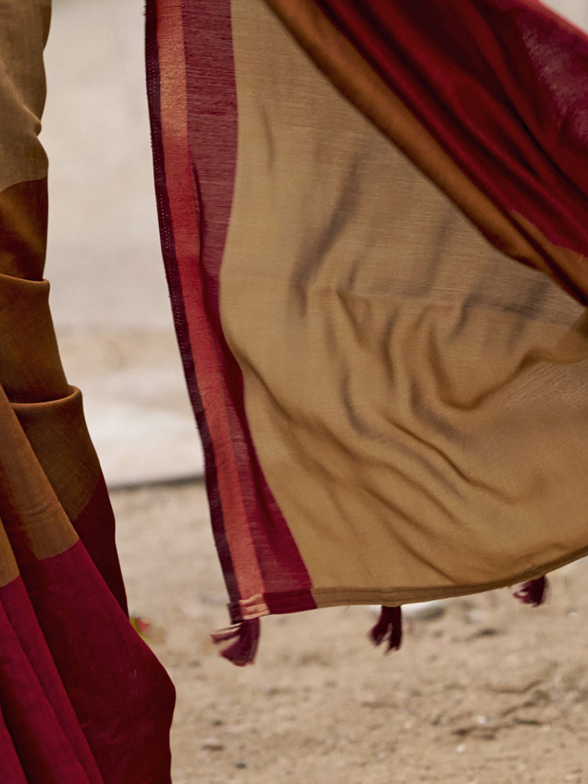 Pallu detail of light brown cotton blend saree showing colorblocked design and zari border