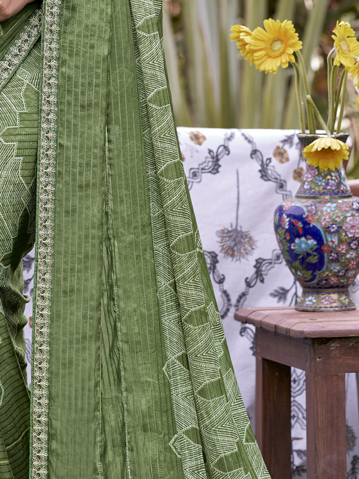 Pallu detail of sea green chiffon saree showing traditional indian motif work and embellished border