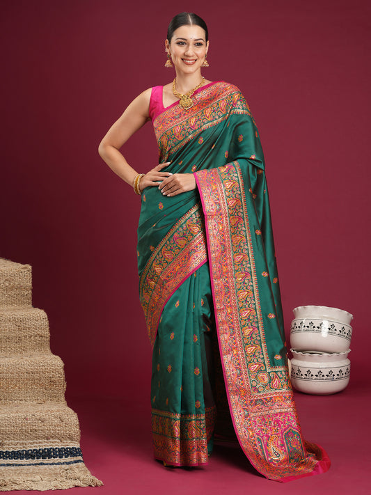 Woman wearing teal green soft silk saree with zari butta (metallic motif) work and pink blouse