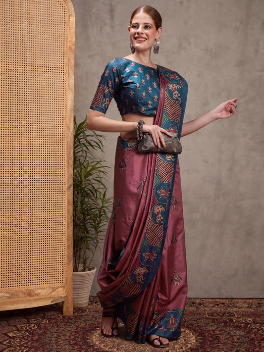 Woman wearing mauve silk blend saree with traditional indian motif work and teal blue blouse