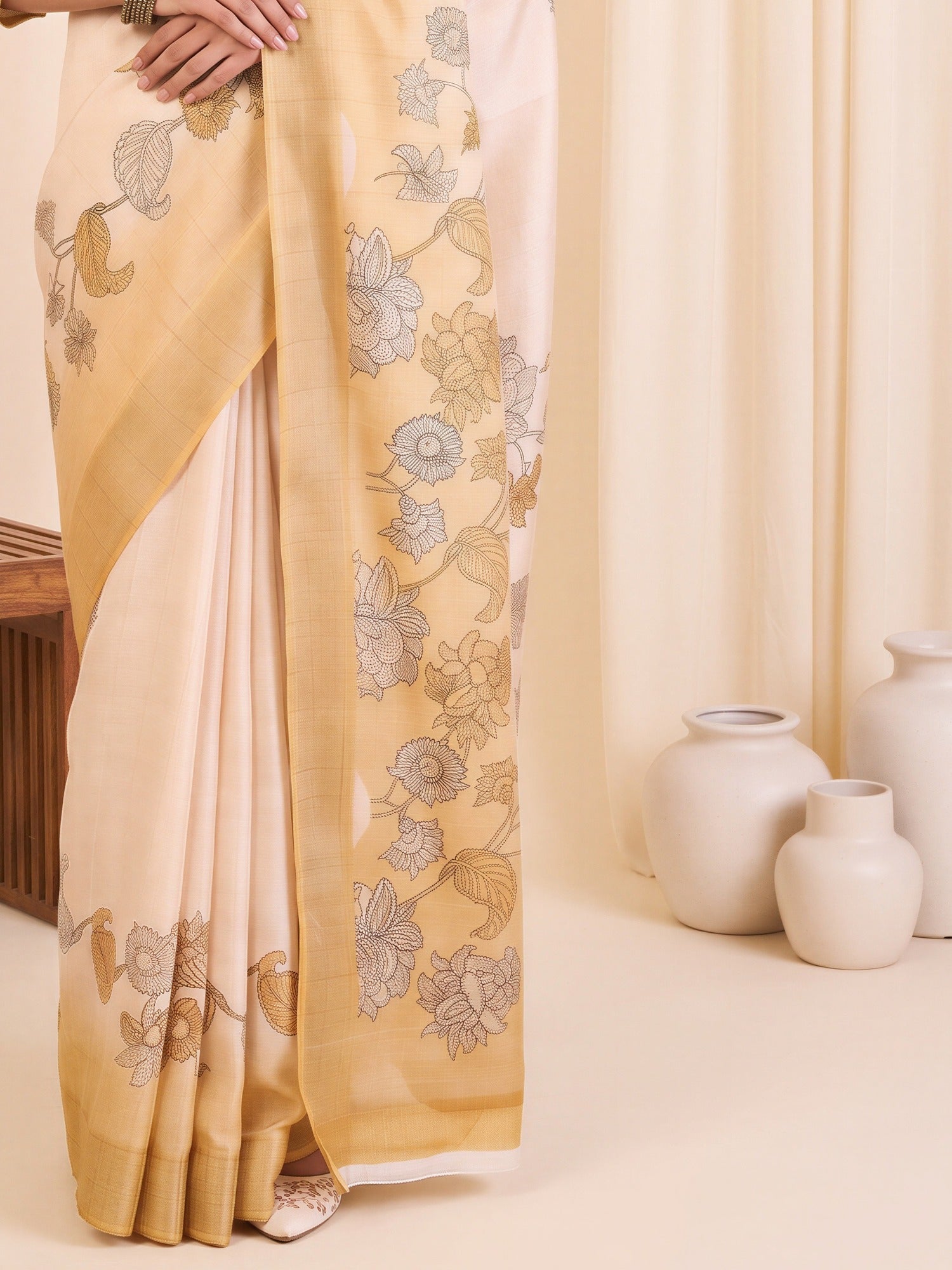 Pallu detail of white satin silk saree showing traditional indian motif work and printed border