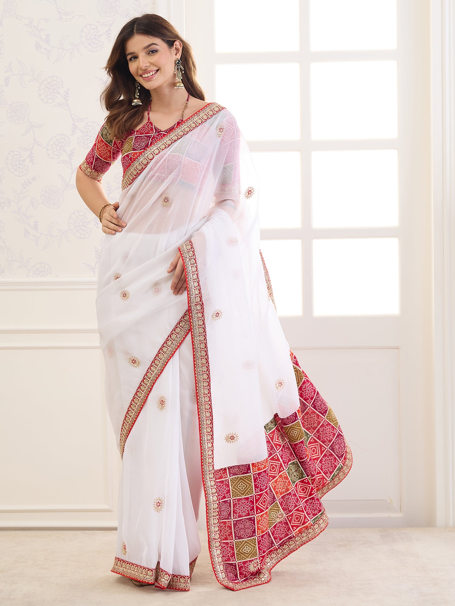 Woman wearing white viscose saree with ornamented surface design and red blouse