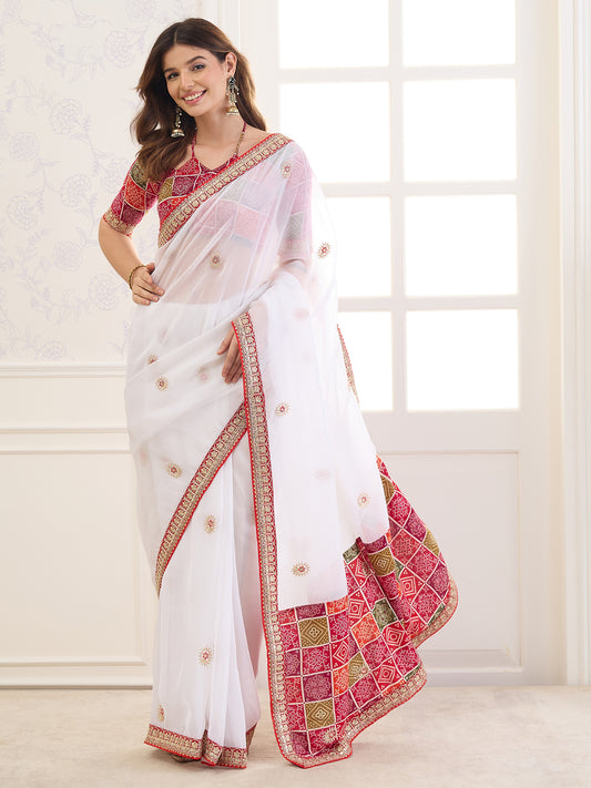 Woman wearing white viscose saree with ornamented surface design and red blouse