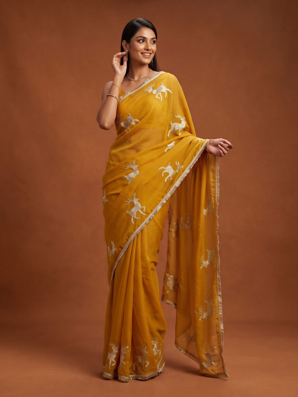 Woman wearing mustard georgette saree with embroidered motif work and mustard blouse