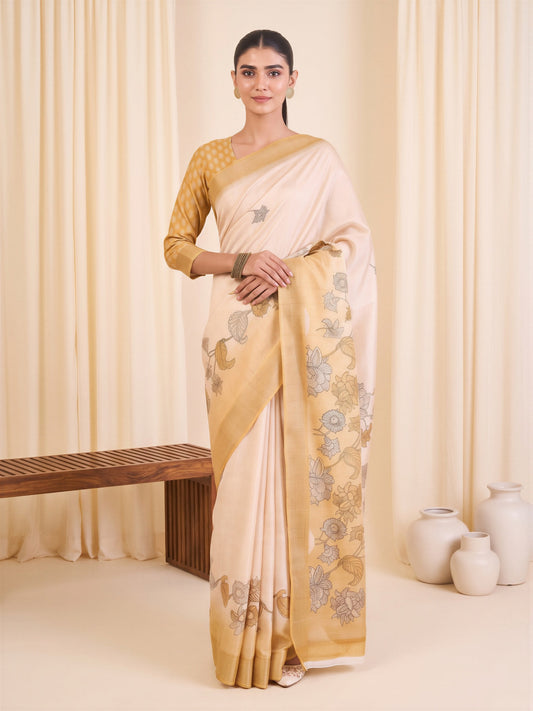 Woman wearing white satin silk saree with traditional indian motif work and mustard blouse