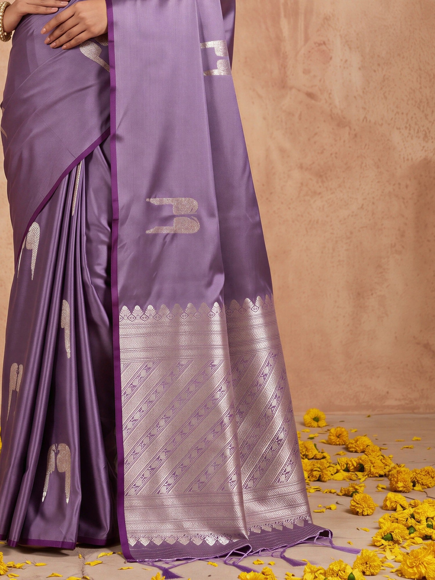 Pallu detail of lavender satin saree showing botanical floral and leaf design and zari border