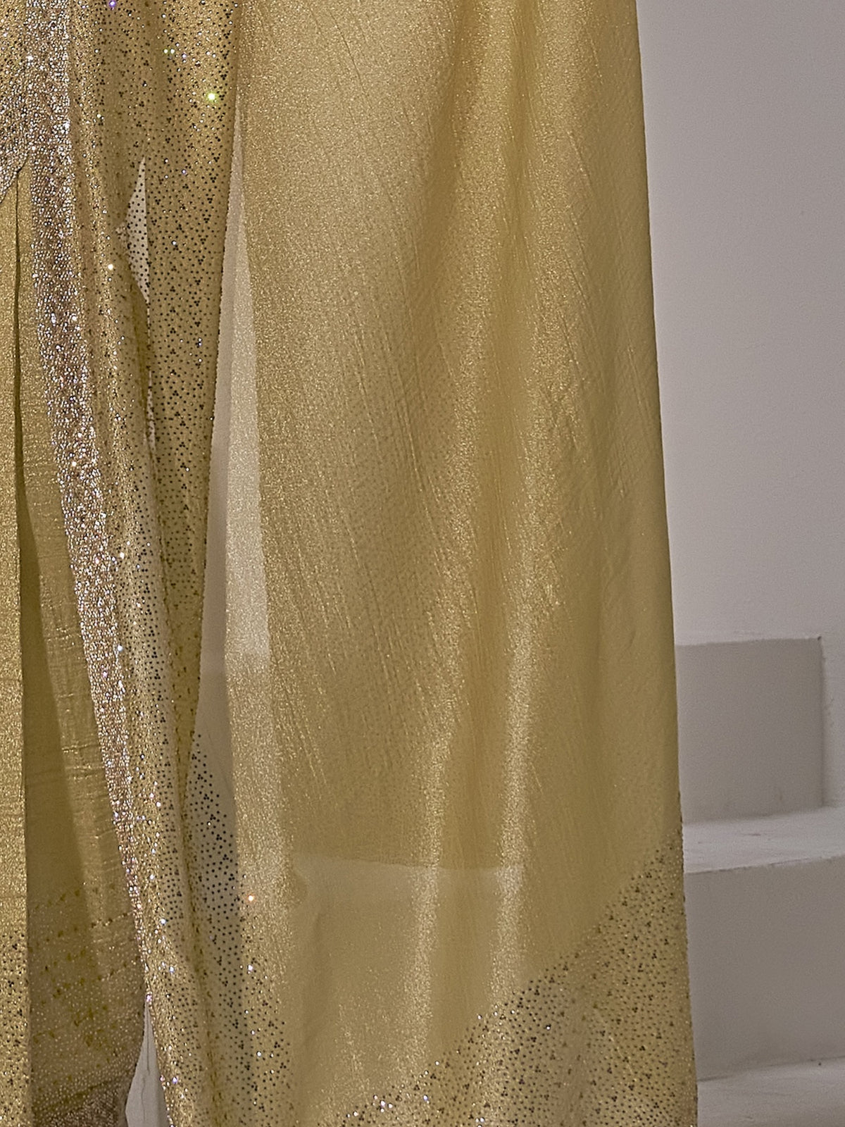 Pallu detail of gold pure silk saree showing clean solid-tone finish and scallop border