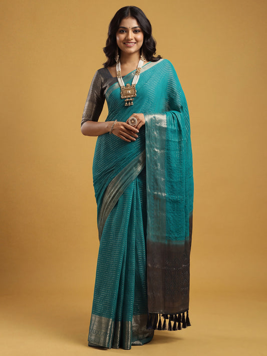 Woman wearing teal blue chiffon saree with striped pattern design and navy blue blouse