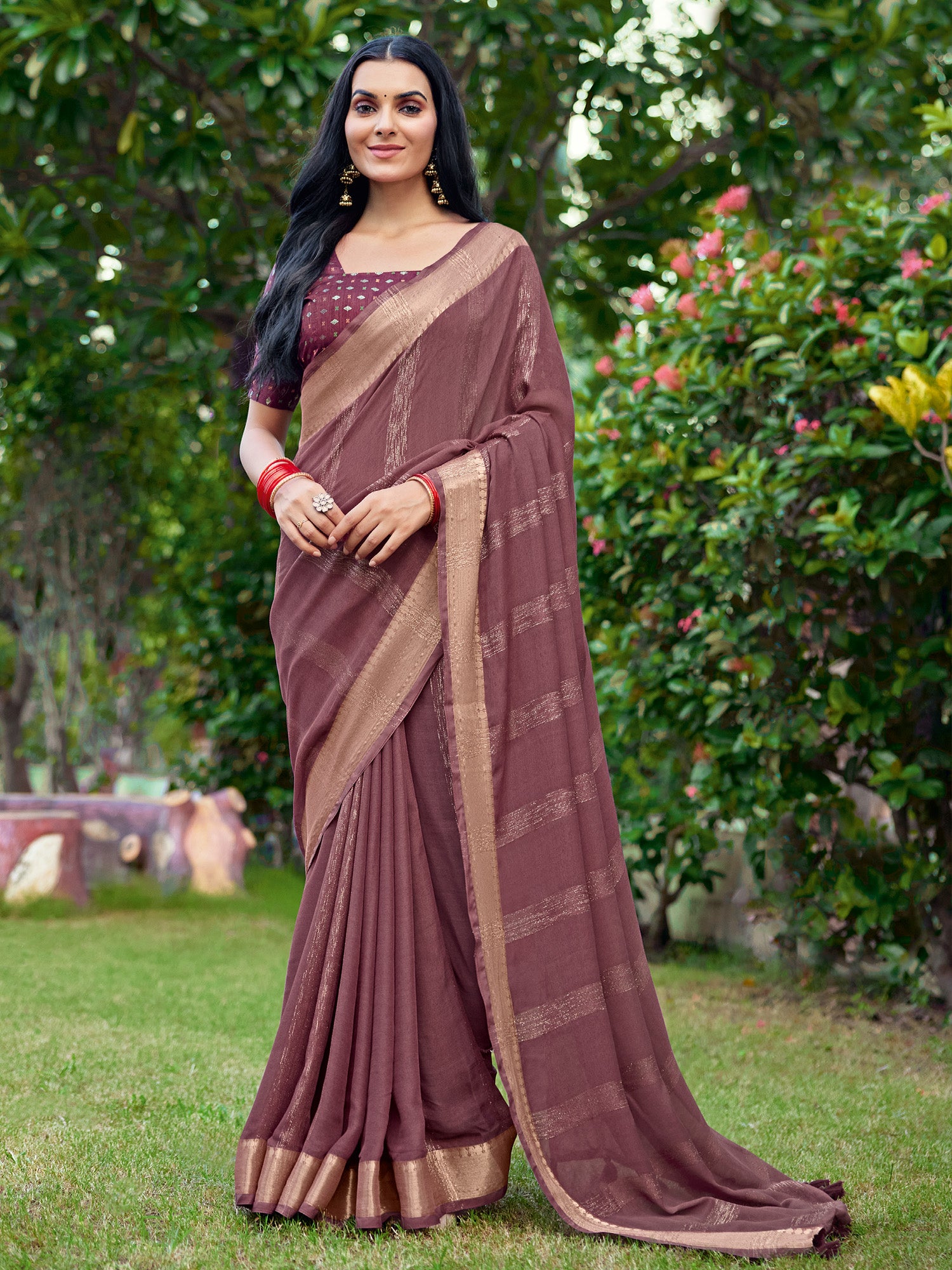 Woman wearing coffee brown georgette saree with striped pattern design and coffee brown blouse