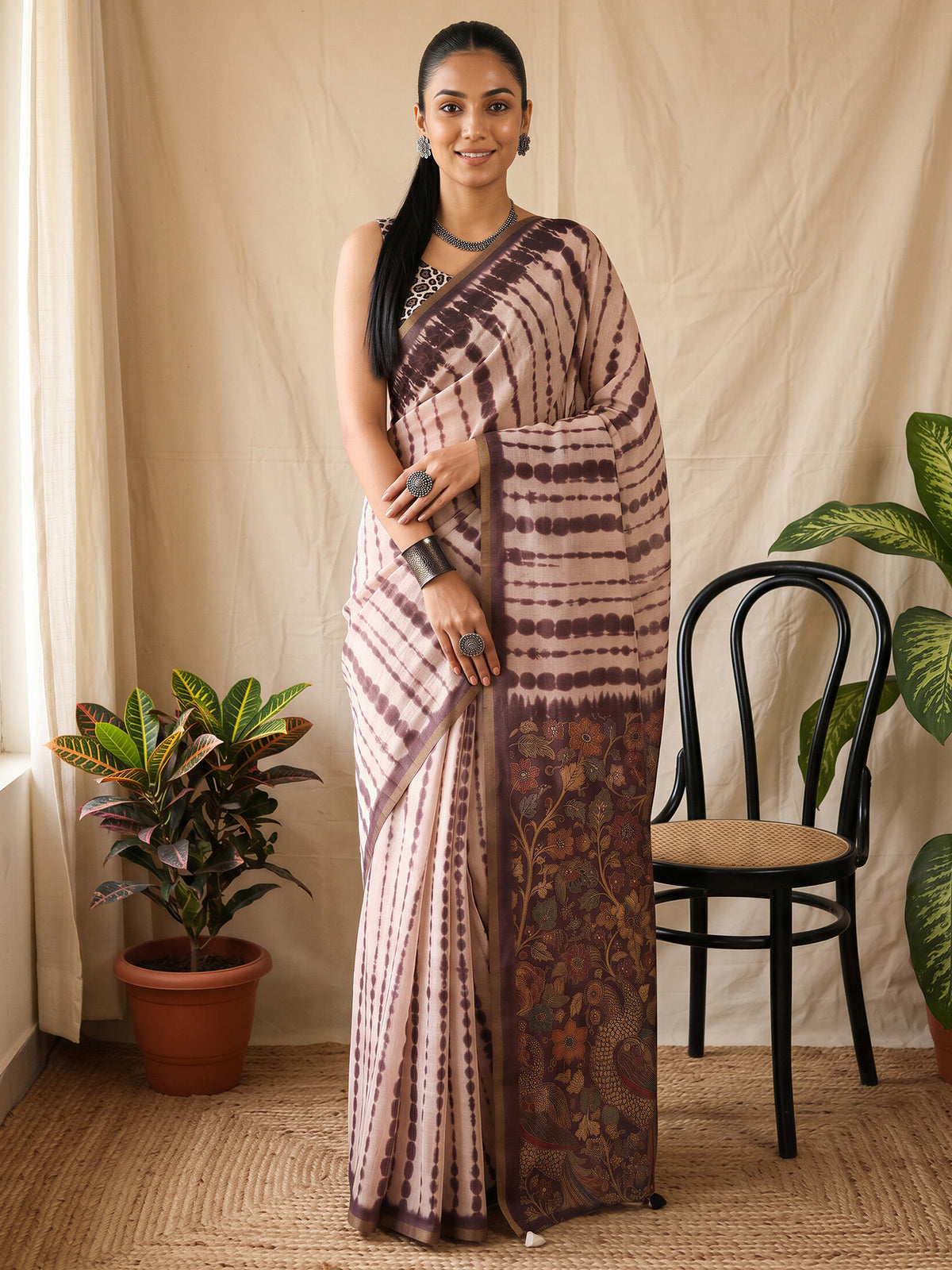 Woman wearing peach cotton blend saree with tie-and-dye resist pattern and peach blouse